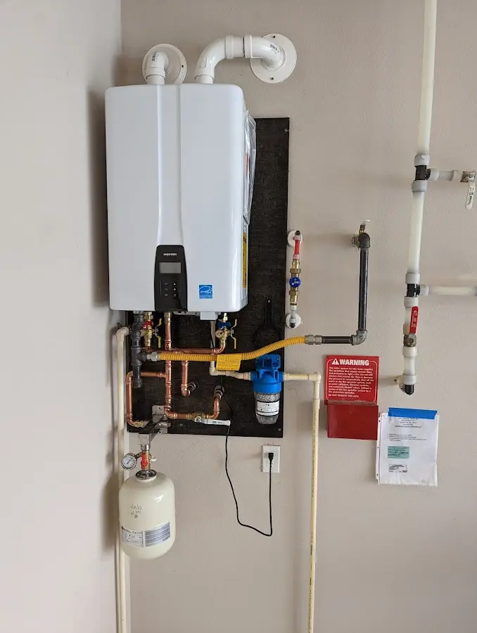 Professional plumber installing copper piping in a Tanglewilde home